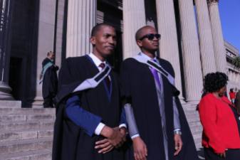 Sikhosonke Tsobo and Ndumiso Mamso (MBBCH) standing tall and proud in front of the signature Wits pillars.Photo: Tendai Dube
