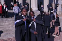 Masters graduates Mpho Mgoepe and Felix Mashinyaidze excited trying to figure out a celebratory handshake. Photo: Tendai Dube