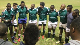DISQUALIFIED: Engineers in a huddle at the Wednesday night game where they beat Men’s Residence, 10 – 5. Photo: Tendai Dube